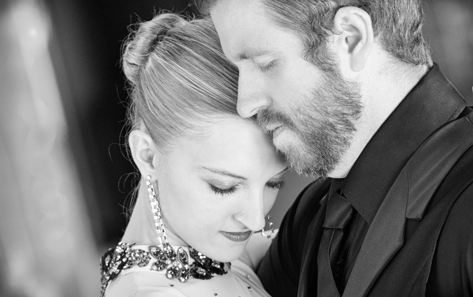 Black-and-white archive portrait of Eric and Bria leaning together