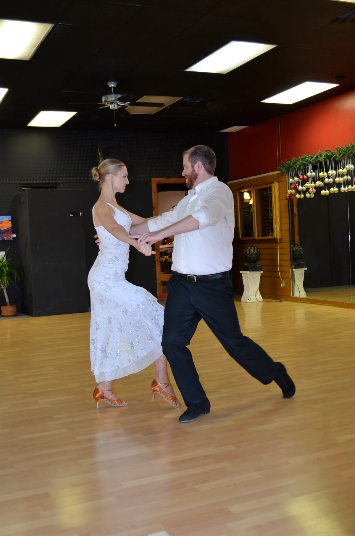 Eric and Bria Bird dancing together on a studio floor